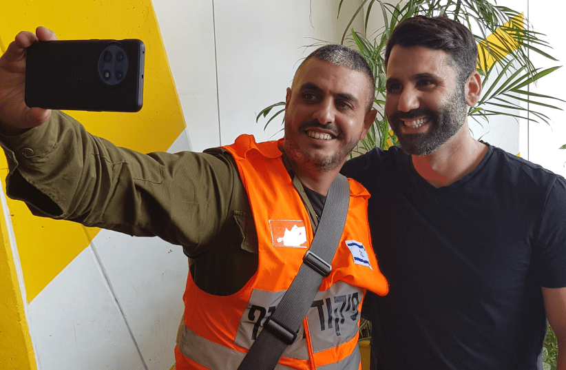  COMEDIAN HEN MIZRACHI (right) with a Homefront Command worker in ‘Stand-up Squad.’ (photo credit: KAN 11)