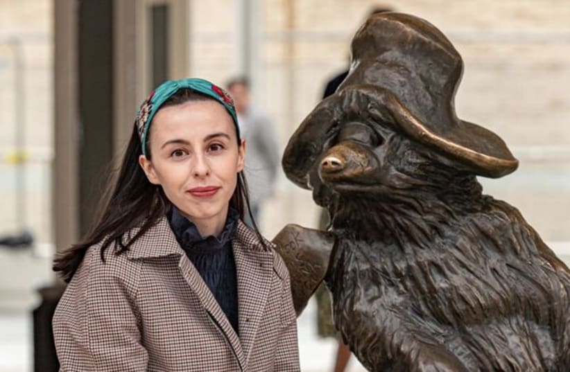  Dr. Amy Williams beside Paddington Bear at London’s Liverpool Station. The fabled character was inspired by the arrivals of many children in the late 1930s. (photo credit: ANDREW KING)