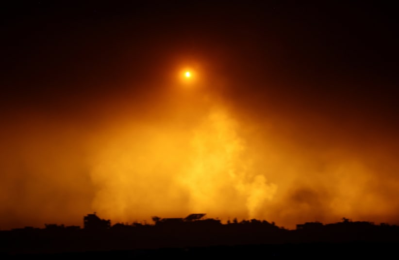  A flare falls over Gaza, amid the ongoing conflict between Israel and the Palestinian Islamist group Hamas, as seen from southern Israel, December 7, 2023. (photo credit: ATHIT PERAWONGMETHA / REUTERS)