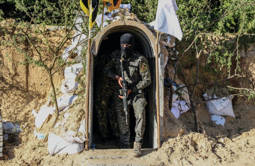 A terrorist from the al-Quds Brigades, the military wing of the Palestinian Islamic Jihad, is seen inside a military tunnel in Beit Hanun, in the Gaza Strip. (photo credit: ATTIA MUHAMMED/FLASH90)
