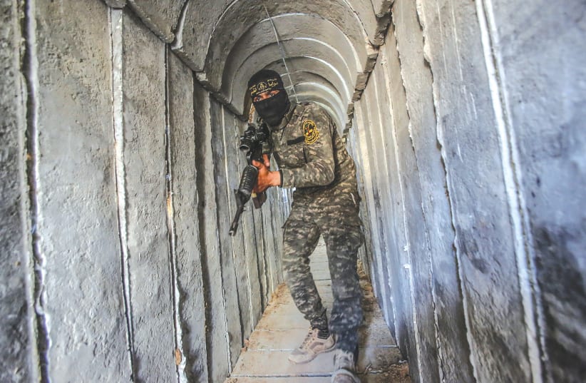  A terrorist from the al-Quds Brigades, the military wing of the Palestinian Islamic Jihad, is seen inside a military tunnel in Beit Hanun, in the Gaza Strip. (photo credit: ATTIA MUHAMMED/FLASH90)