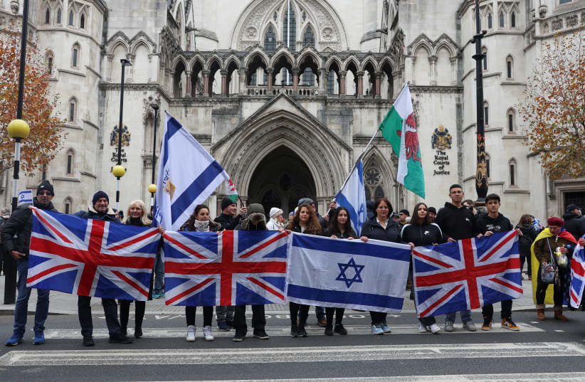  Demonstrators hold Israeli and British flags outside the Law Courts, during a march against antisemitism, after an increase in the UK, during a temporary truce between the Palestinian Islamist group Hamas and Israel, in London, Britain November 26, 2023. (photo credit: REUTERS/Susannah Ireland)