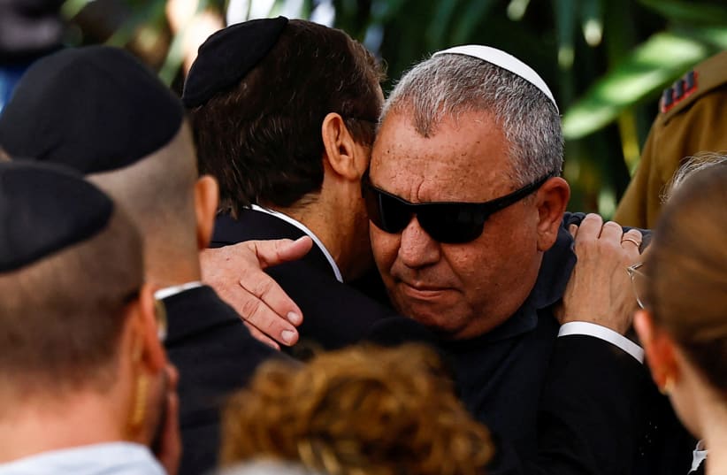 Israeli cabinet minister and former military chief Gadi Eizenkot is consoled by Israeli President Isaac Herzog, as he attends the funeral of his son Gal Meir Eisenkot, 25, an Israeli solider, who was killed in northern Gaza during the ongoing ground operation by Israel's military in the Gaza Strip,  (photo credit: REUTERS/CLODAGH KILCOYNE)