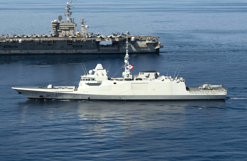  The French Aquitaine-class frigate FS Languedoc (D653), front, sails alongside the Nimitz-class aircraft carrier USS Dwight D. Eisenhower (CVN 69) in the Mediterranean Sea, March 27, 2021. (photo credit: Mass Communication Specialist 3rd Class Sawyer Haskins/US Navy)