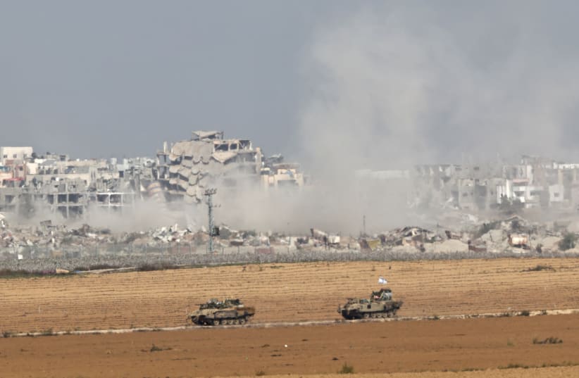  Israeli military vehicles manoeuvre near the border with Gaza in Israel, as seen from southern Israel, December 10, 2023 (photo credit: REUTERS/ATHIT PERAWONGMETHA)