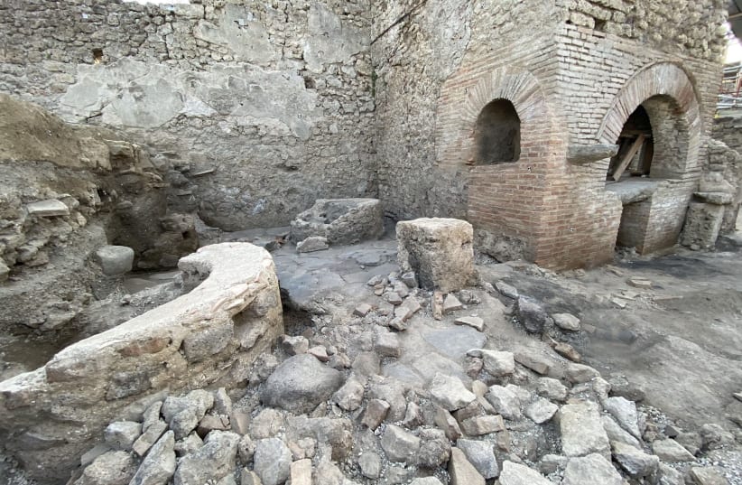 A view shows a "bakery-prison" where slaves and donkeys were locked up to grind the grain needed to make bread, in the ancient archeological site of Pompeii, Italy, in this handout photo obtained by Reuters on December 8, 2023. (photo credit: Parco archeologico di Pompei/Handout via REUTERS)