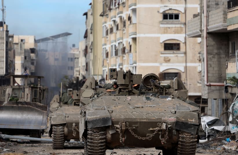  Israeli tanks operate in Gaza City, amid the ongoing ground operation of the Israeli army against Hamas, in the Gaza Strip, November 22, 2023.  (photo credit: REUTERS/Ronen Zvulun)