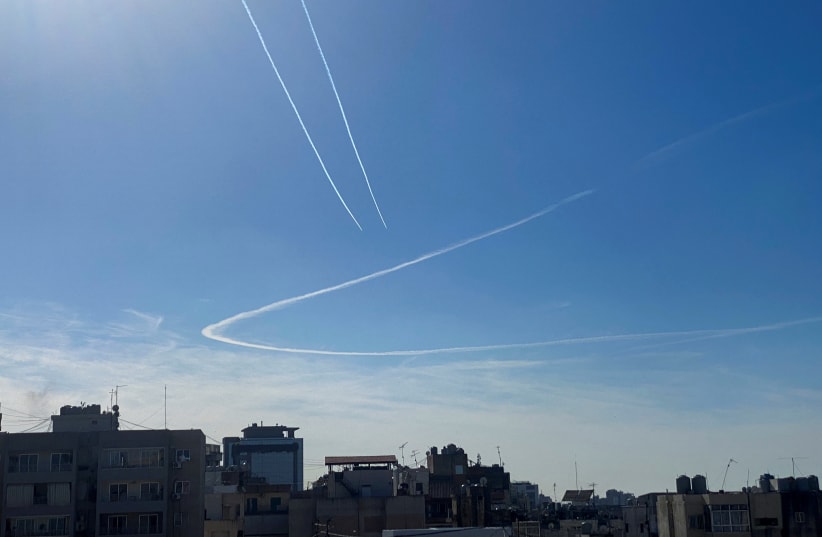  Aircraft leave vapor trails in the sky above Beirut, Lebanon December 10, 2023. (photo credit: CYNTHIA KARAM/REUTERS)