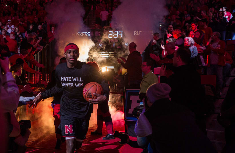  Nebraska guard Glynn Watson Jr., wearing a "Hate Will Never Win" T-shirt, takes the court in Lincoln, Nebraska, Feb. 10, 2018. The message was a response to the presence of a vocal white supremacist on the university campus.  (photo credit: John Peterson/Icon Sportswire via Getty Images)