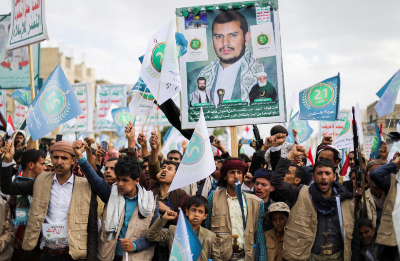 Supporters of Yemen's Houthis hold a poster of the top Houthi leader Abdul-Malik Badruddin al-Houthi during a rally in Sanaa in September 2021. (photo credit: REUTERS)