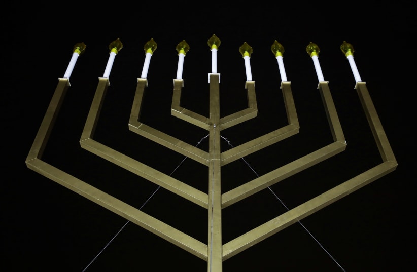  The National Menorah is illuminated after a lighting ceremony in Washington. (photo credit: REUTERS)