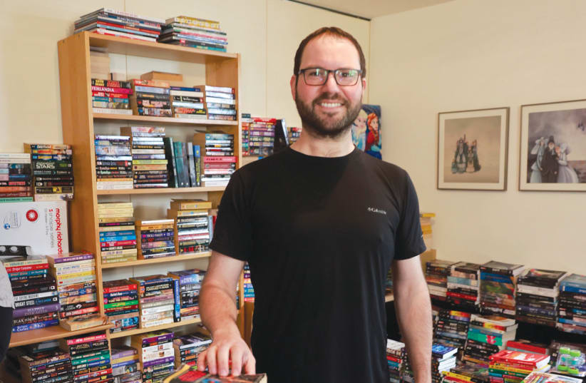  NOT ALL heroes wear capes: Jerusalemite Arye Dobuler is seen with his huge collection of comic books and sci-fi/fantasy novels available for affordable purchase in the German Colony. (photo credit: MARC ISRAEL SELLEM)