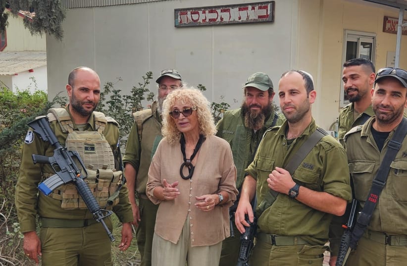  RACHEL FRICKER outside the Kibbutz Be'eri synagogue with IDF soldiers.  (photo credit: Courtesy Fricker family)