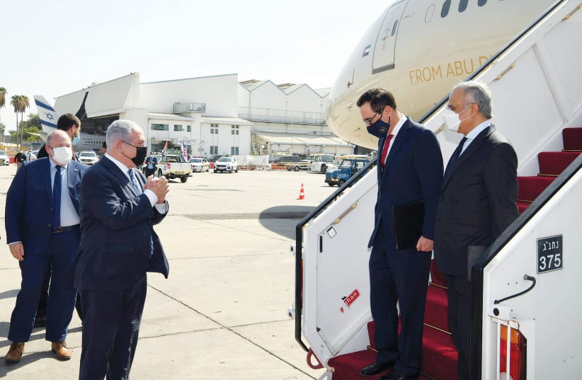  PRIME MINISTER Benjamin Netanyahu greets US Treasury secretary Steve Mnuchin and UAE’s Minister of State for Financial Affairs at Ben-Gurion Airport.  (photo credit: WAM/HANDOUT VIA REUTERS)