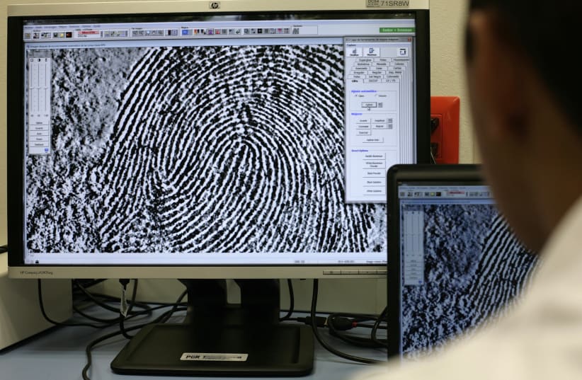  A fingerprint expert checks a fingerprint on a monitor at the attorney's general crime laboratory in Mexico City July 12, 2011. (photo credit: REUTERS/Bernardo Montoya)