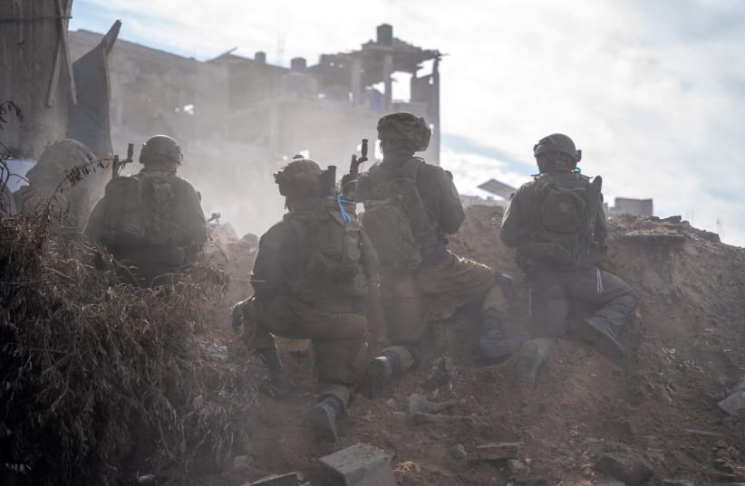  IDF soldiers operate in the Gaza Strip amid the ongoing conflict between Israel and the Palestinian Islamist group Hamas, in this handout picture released on December 17, 2023. (photo credit: IDF/Handout via REUTERS)