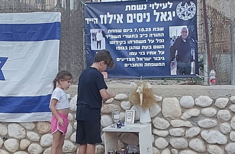  Children visit a makeshift memorial in Ofakim, where B'ezri is providing assistance to those in greatest need in the aftermath of the loss of 50 community members who gave their lives in defense of the city. (photo credit: EVA WEISS)