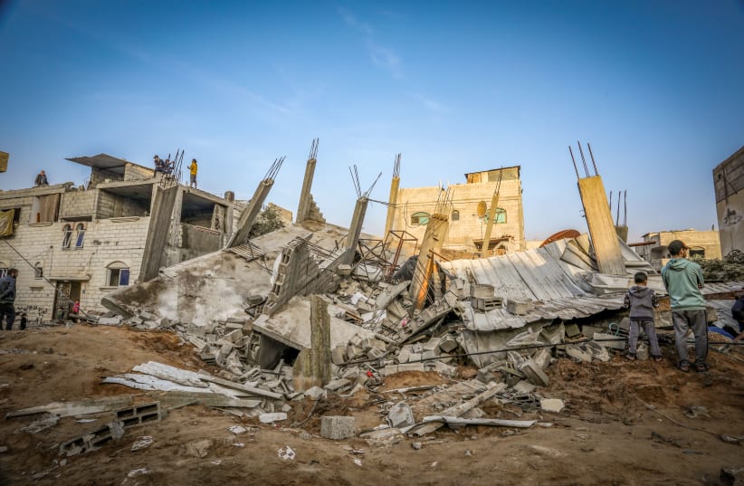  Palestinians at the site of an Israeli air strike in Rafah, in the southern Gaza Strip, on December 17, 2023.  (photo credit: ABED RAHIM KHATIB/FLASH90)