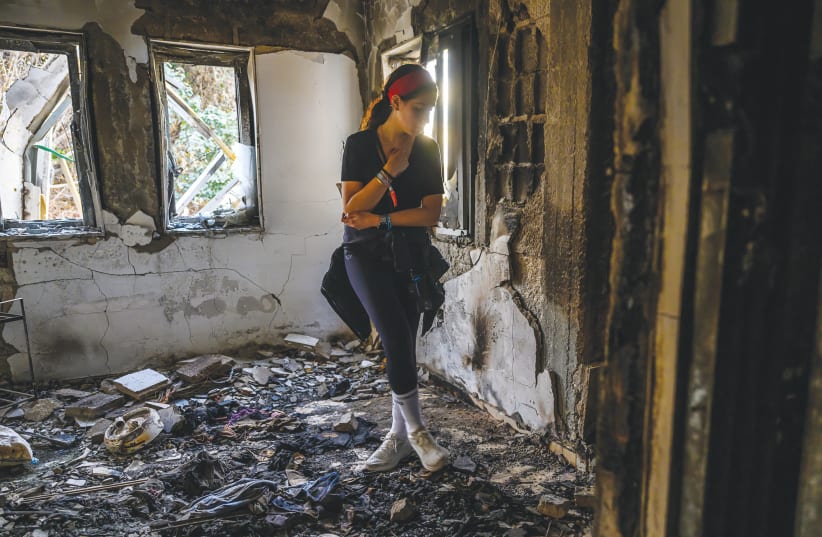   VOLUNTEER from London visits a home gutted by fire in Be’eri this week. The test of victory is in the world of facts: if the residents of the South do not return to their homes, we will not have won, says the writer.  (photo credit: Alexi J. Rosenfeld/Getty Images)