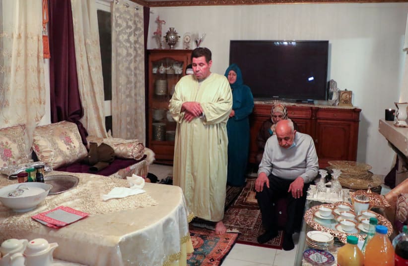  Muslim family including Aziz El Moujahid, France, May 1, 2021. his wife Lalla Aicha El Moujahid and two friends of the family Abdullah and Rabiah pray before breaking fast at Ramadan during the nationwide curfew, during Covid-19 pandemic,  (photo credit: REUTERS/Yiming Woo)