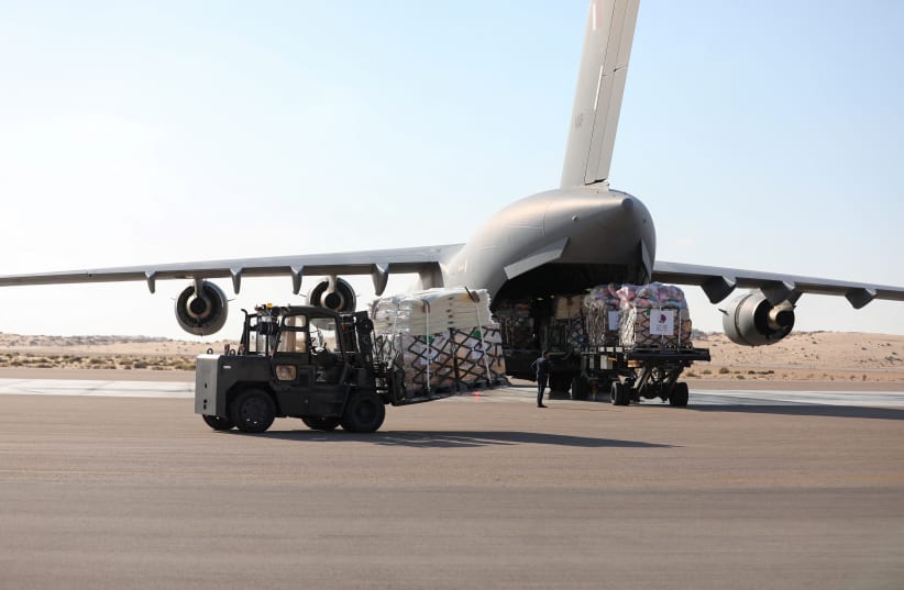  Workers unload humanitarian aid destined for the Gaza Strip via Rafah border area, during a temporary truce between Palestinian Islamist group Hamas and Israel, at Al Arish airport, in Al Arish, Egypt, November 30, 2023. (photo credit: REUTERS/MOHAMED ABD EL GHANY)