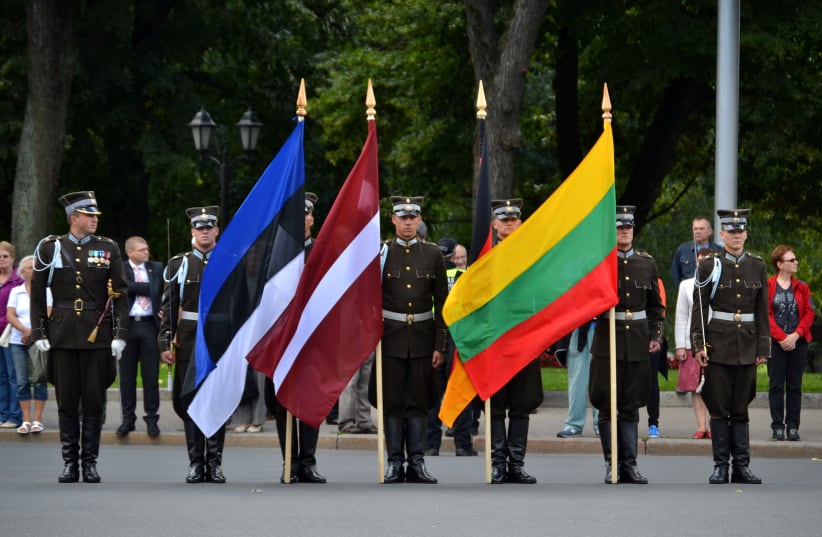  The flags, from left to right, of Estonia, Latvia and Lithuania at a ceremony in Riga, Latvia, in 2012. (photo credit: Pablo Andrés Rivero/JTA)