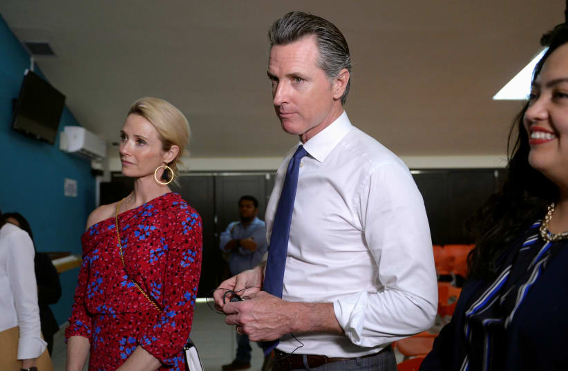 Governor of US state of California Gavin Newsom and his wife Jennifer Siebel Newsom visit the premises of a migrant assistance office in San Salvador, El Salvador April 8, 2019. (photo credit: REUTERS/Jessica Orellana)