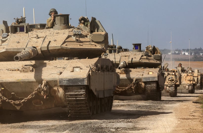   Israeli tanks and military vehicles take position near Israel's border with the Gaza Strip, in southern Israel, October 13, 2023 (photo credit: REUTERS/VIOLETA SANTOS MOURA)