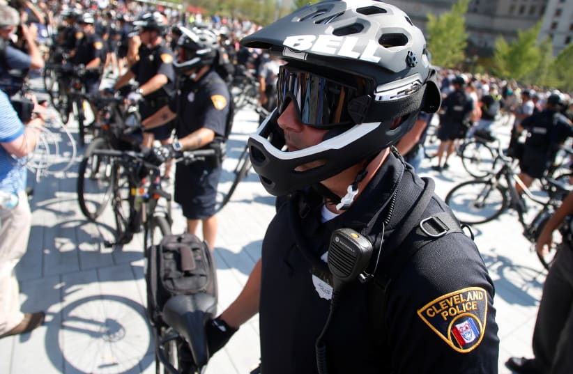  Cleveland Police officers on bicycles separate protesters near the Republican National Convention in Cleveland, Ohio, (photo credit: REUTERS/JIM URQUHART)
