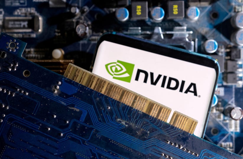   A smartphone with a displayed NVIDIA logo is placed on a computer motherboard in this illustration taken March 6, 2023 (photo credit: DADO RUVIC/REUTERS ILLUSTRATION)