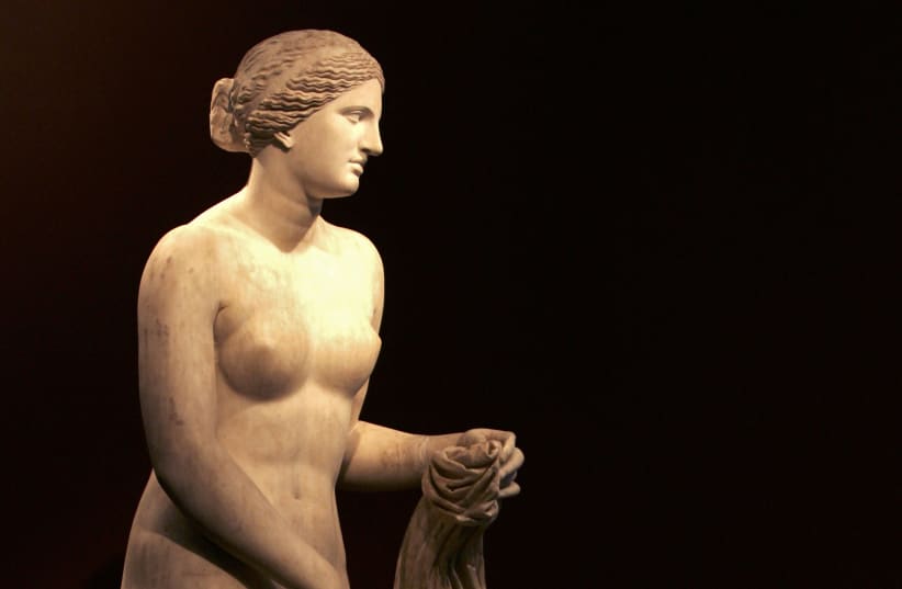  A man admires a marble statue of Aphrodite, known as the Velvedere Venus, on display at the Praxiteles exhibition in the National Archaeological Museum in Athens July 26, 2007. (photo credit: REUTERS/Yiorgos Karahalis (GREECE))