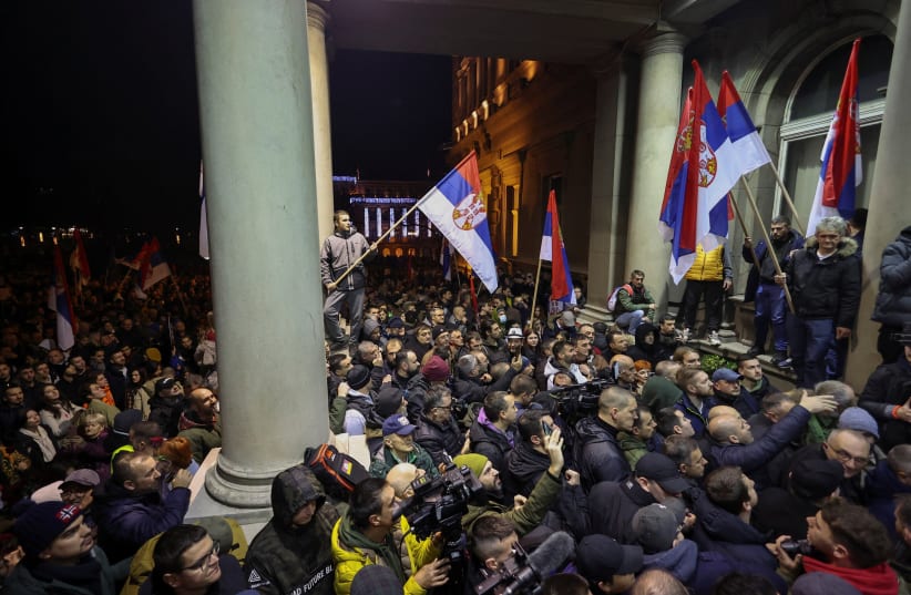  Supporters of the opposition 'Serbia Against Violence' (SPN) protest in front of the city hall, after the SPN alleged major election law violations in the Belgrade city and parliament races, in Belgrade, Serbia, December 24, 2023. (photo credit: REUTERS)