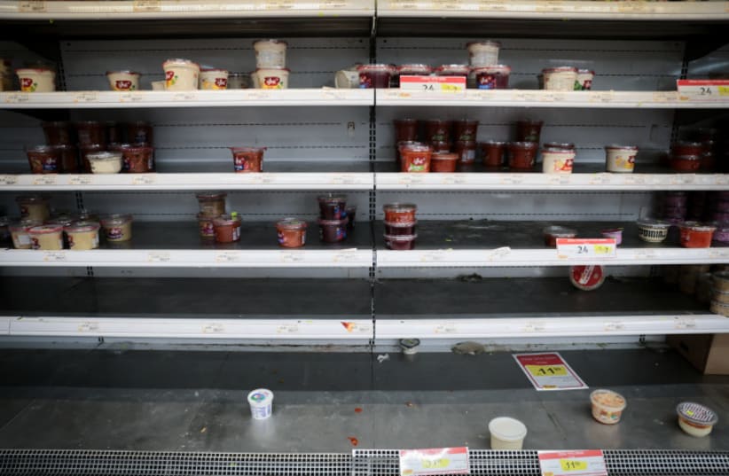  The empty shelves at a supermarket in Talpiot, Jerusalem, after the IDF Home Front Command issued a recommendation to the Israeli public to prepare food/water/necessities for a possible 72 hrs of staying sheltered. October 10, 2023 (photo credit: NOAM REVKIN FENTON/FLASH90)