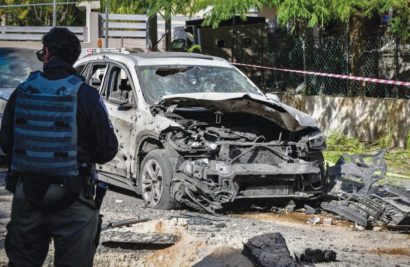  THE AFTERMATH of a Gaza rocket attack in Holon earlier this month: The fear fueled by the war may create the impression that democratic values must be sacrificed for victory and security, the writer cautions.  (photo credit: AVSHALOM SASSONI/FLASH90)