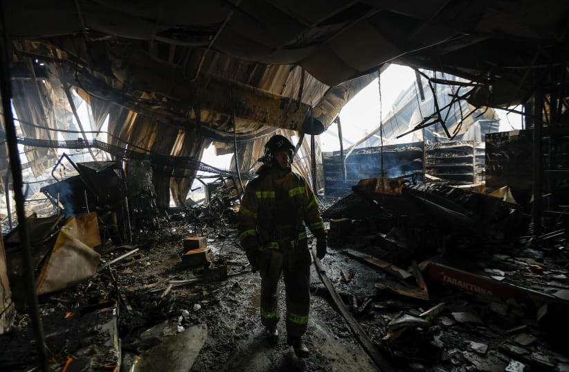  A firefighter walks amid debris of the destroyed shopping mall Galaktika that was hit by recent shelling in the course of Russia-Ukraine conflict in the town of Horlivka (Gorlovka) in the Donetsk region, Russian-controlled Ukraine, December 25, 2023.  (photo credit: REUTERS/ALEXANDER ERMOCHENKO)