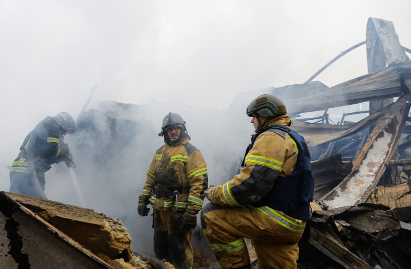  Firefighters work amid debris of the destroyed shopping mall Galaktika that was hit by recent shelling in the course of Russia-Ukraine conflict in the town of Horlivka (Gorlovka) in the Donetsk region, Russian-controlled Ukraine, December 25, 2023.  (photo credit: REUTERS/ALEXANDER ERMOCHENKO)