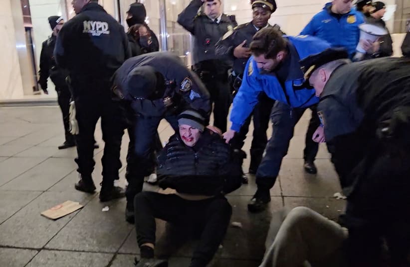 Police detain a demonstrator during a protest in solidarity with Palestinians, December 25, 2023 (photo credit: X/@MerruX/via REUTERS )