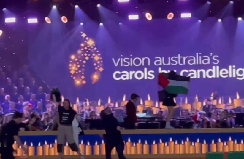 Pro-Palestinian protesters disrupt Melbourne's Carols By Candlelight Christmas Eve event, 2023. (photo credit: SCREENSHOT/X)
