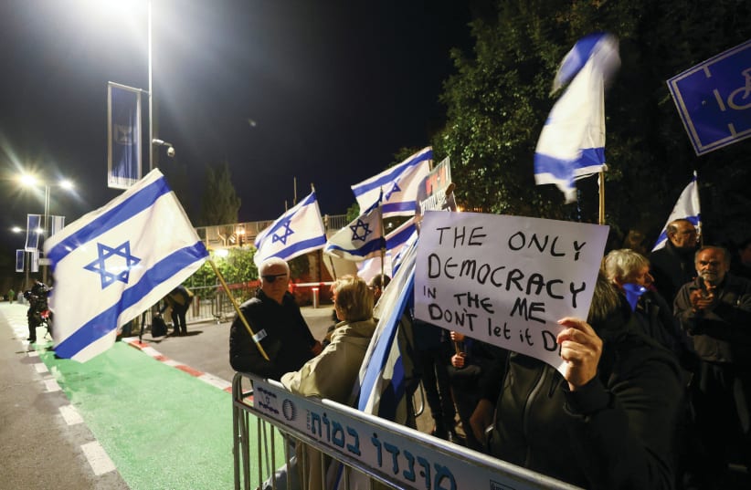  ISRAELIS DEMONSTRATE outside the residence of President Isaac Herzog as he hosts talks over judicial reforms, in Jerusalem in March. (photo credit: RONEN ZVULUN/REUTERS)