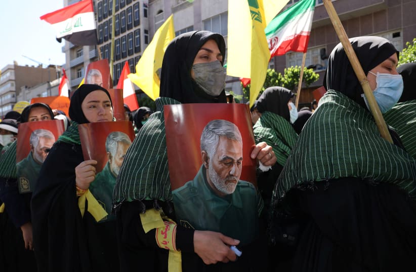  Iranian women hold posters of senior Iranian military commander General Qassem Soleimani as they attend a rally marking the annual Quds Day, or Jerusalem Day, on the last Friday of the holy month of Ramadan in Tehran, Iran April 14, 2023. (photo credit: Majid Asgaripour/WANA/via Reuters)