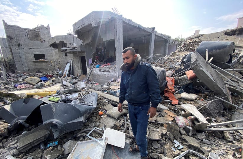  Palestinian man Ibrahim Al-Haj Youssef, who lost four of his children and his wife in an Israeli air strike, stands amidst debris, amid the ongoing conflict between Israel and Hamas, at the Maghazi camp, in the central Gaza Strip, December 25, 2023.  (photo credit: REUTERS/DOAA ROUQA)