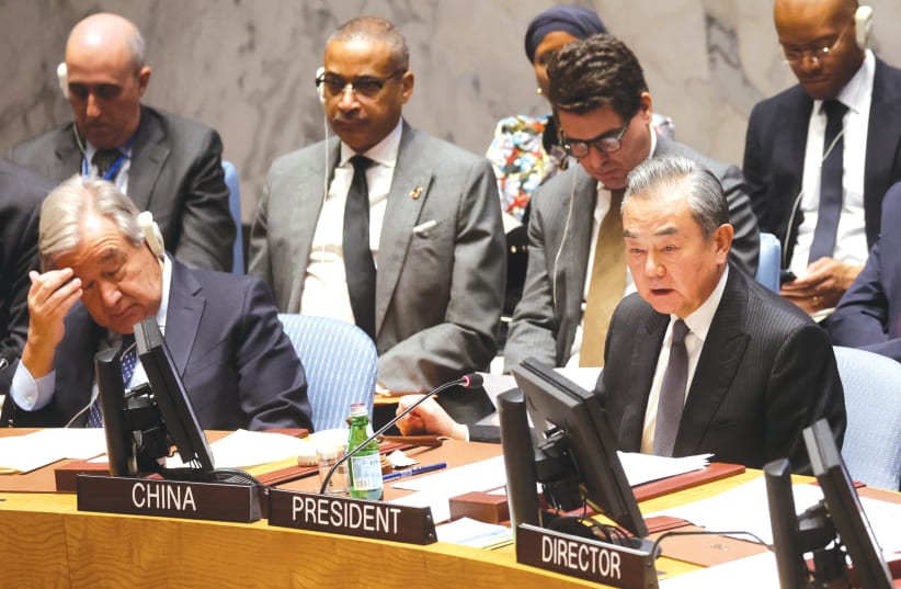  CHINA'S FOREIGN Minister Wang Yi and United Nations Secretary-General Antonio Guterres attend a UN Security Council meeting on the Israel-Hamas war, in late November. (photo credit: BRENDAN MCDERMID/REUTERS)