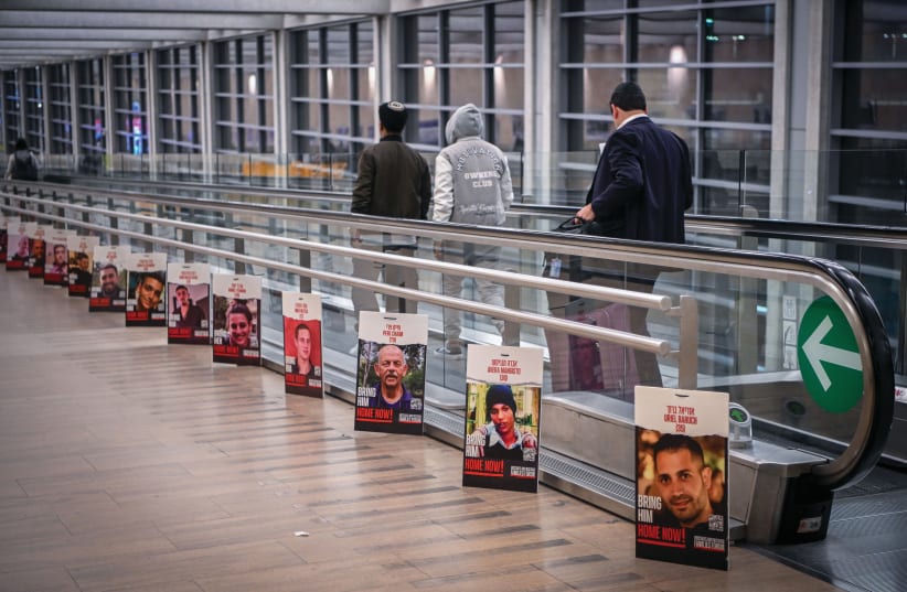  PICTURES OF HOSTAGES being held by Hamas in Gaza are displayed at Ben-Gurion Airport last week. (photo credit: Arie Leib Abrams/Flash90)