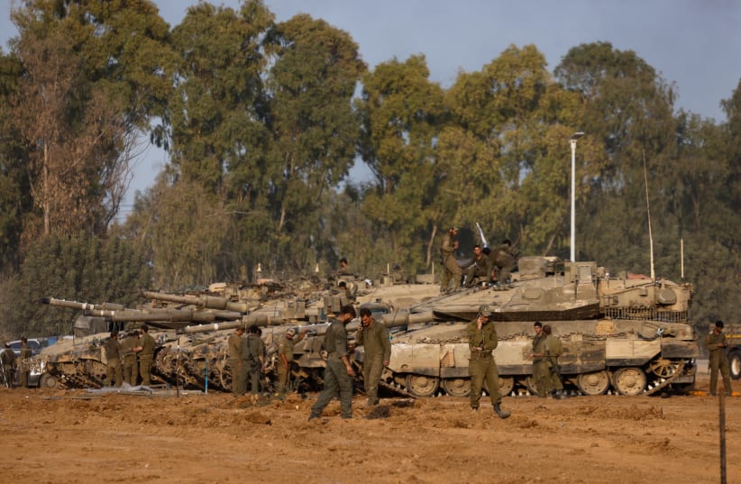  Israeli soldiers stand by tanks, near the Israel-Gaza border, December 30, 2023 (photo credit: AMIR COHEN/REUTERS)