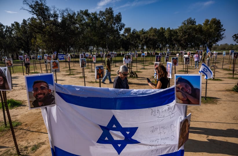 People visit the site of the Nova music festival massacre, in Re'im, near the Israeli-Gaza border, December 31, 2023 (photo credit: YONATAN SINDEL/FLASH90)