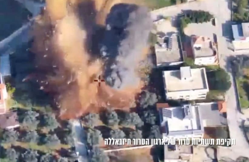  An aerial view of a strike on a building and surrounding area in the location given as Lebanon in this still image taken from handout video released December 30, 2023. (photo credit: IDF/Handout via REUTERS)