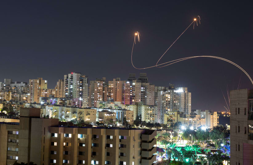  Israel's Iron Dome anti-missile system intercepts rockets launched from the Gaza Strip, amid the ongoing conflict between Israel and the Palestinian Islamist group Hamas, as seen from Ashkelon, Israel, December 25, 2023.  (photo credit: AMIR COHEN/REUTERS)