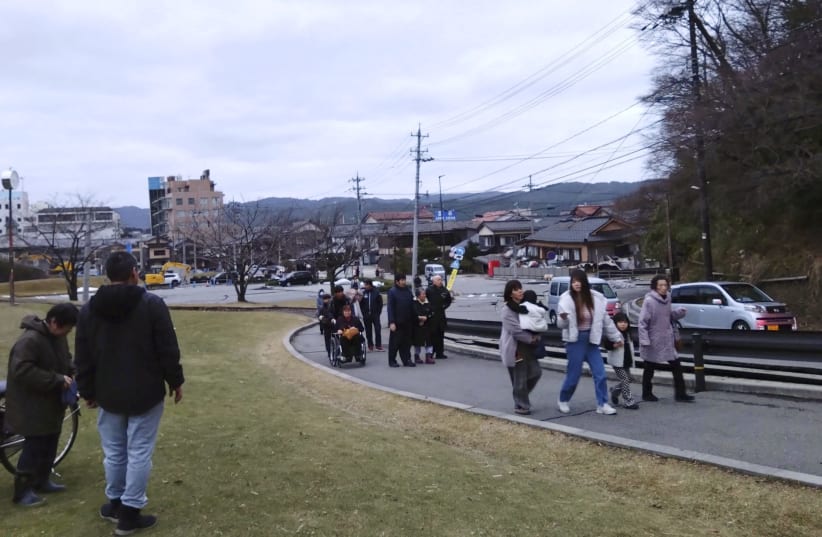  People evacuate toward higher ground after a tsunami warning caused by an earthquake in Wajima, Ishikawa prefecture, Japan January 1, 2024. (photo credit:  Kyodo via REUTERS)
