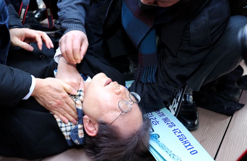  South Korea's opposition party leader Lee Jae-myung falls after being attacked by an unidentified man during his visit to Busan, South Korea, January 2, 2024. (photo credit: YONHAP VIA REUTERS)