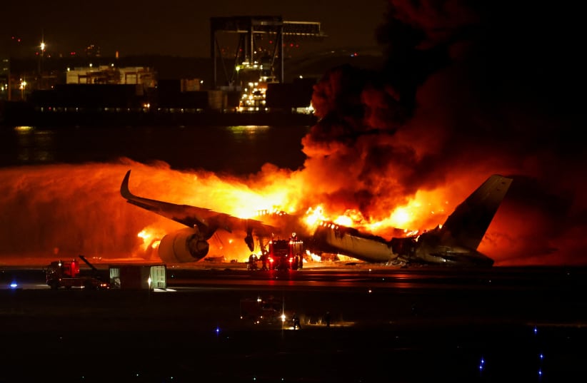  Firefighters work at Haneda International Airport after Japan Airlines' A350 airplane caught on fire, in Tokyo, Japan January 2, 2024. (photo credit: REUTERS/ISSEI KATO)
